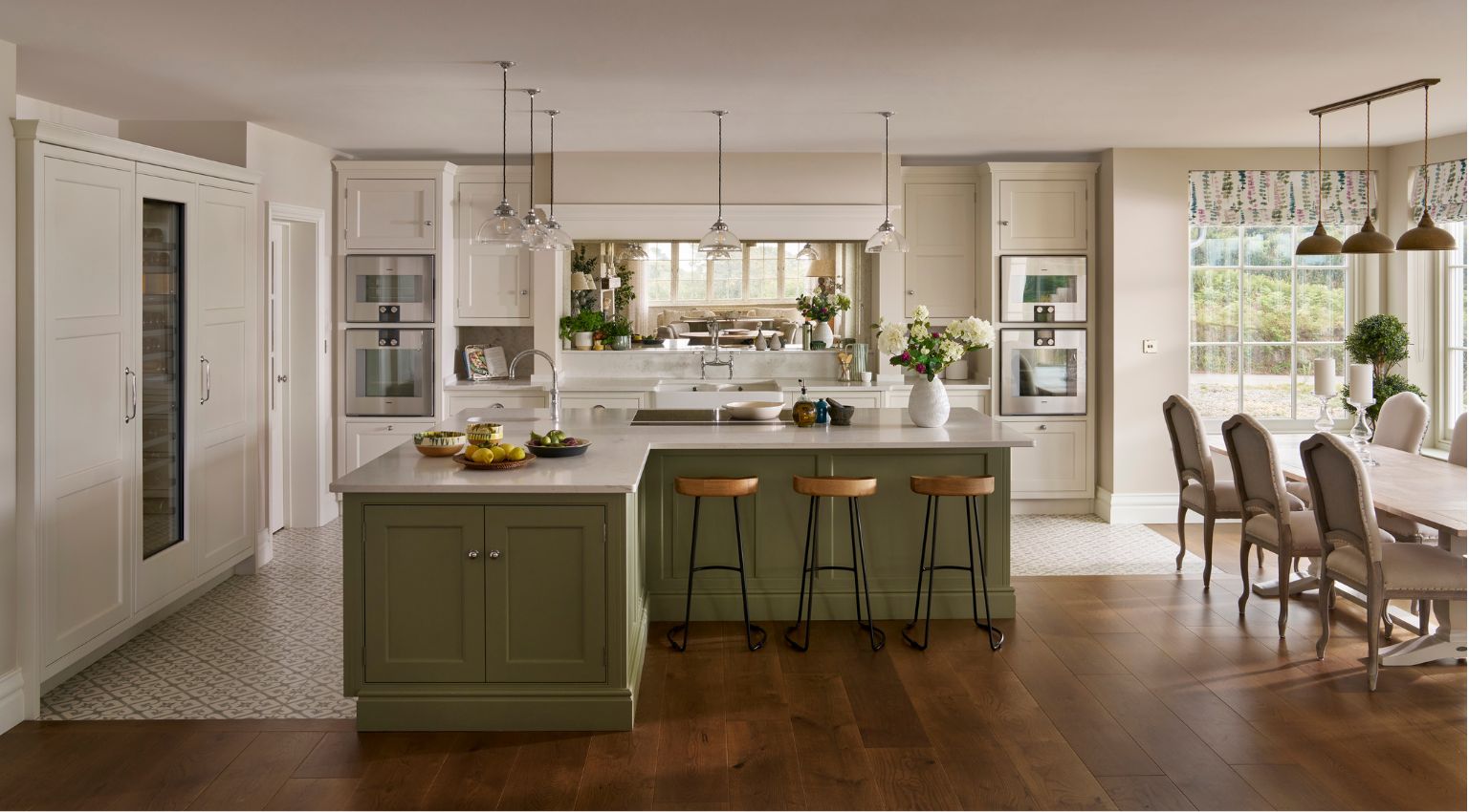 Green kitchen island in a neutral kitchen