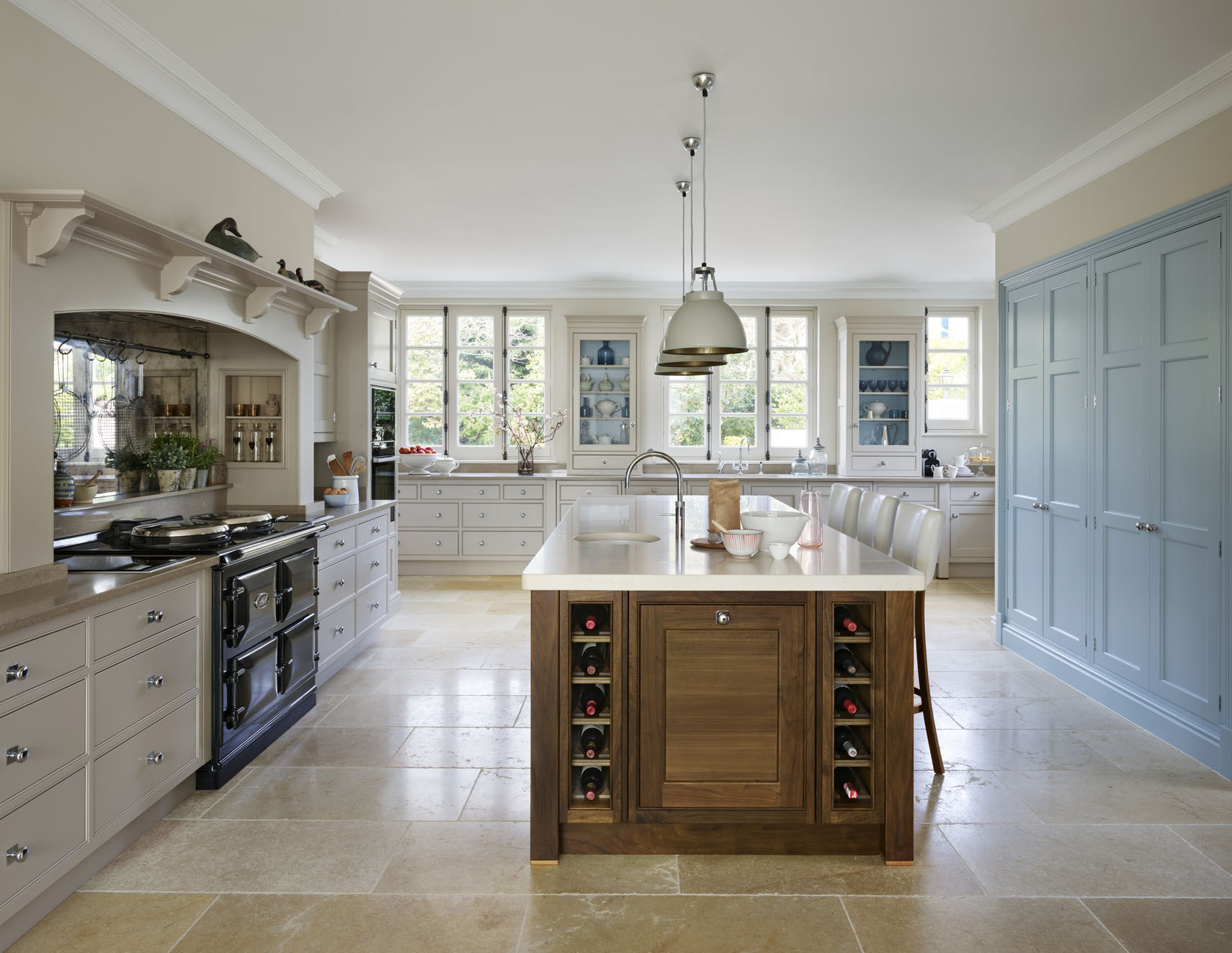 Dark walnut kitchen island with blue accent cupboards