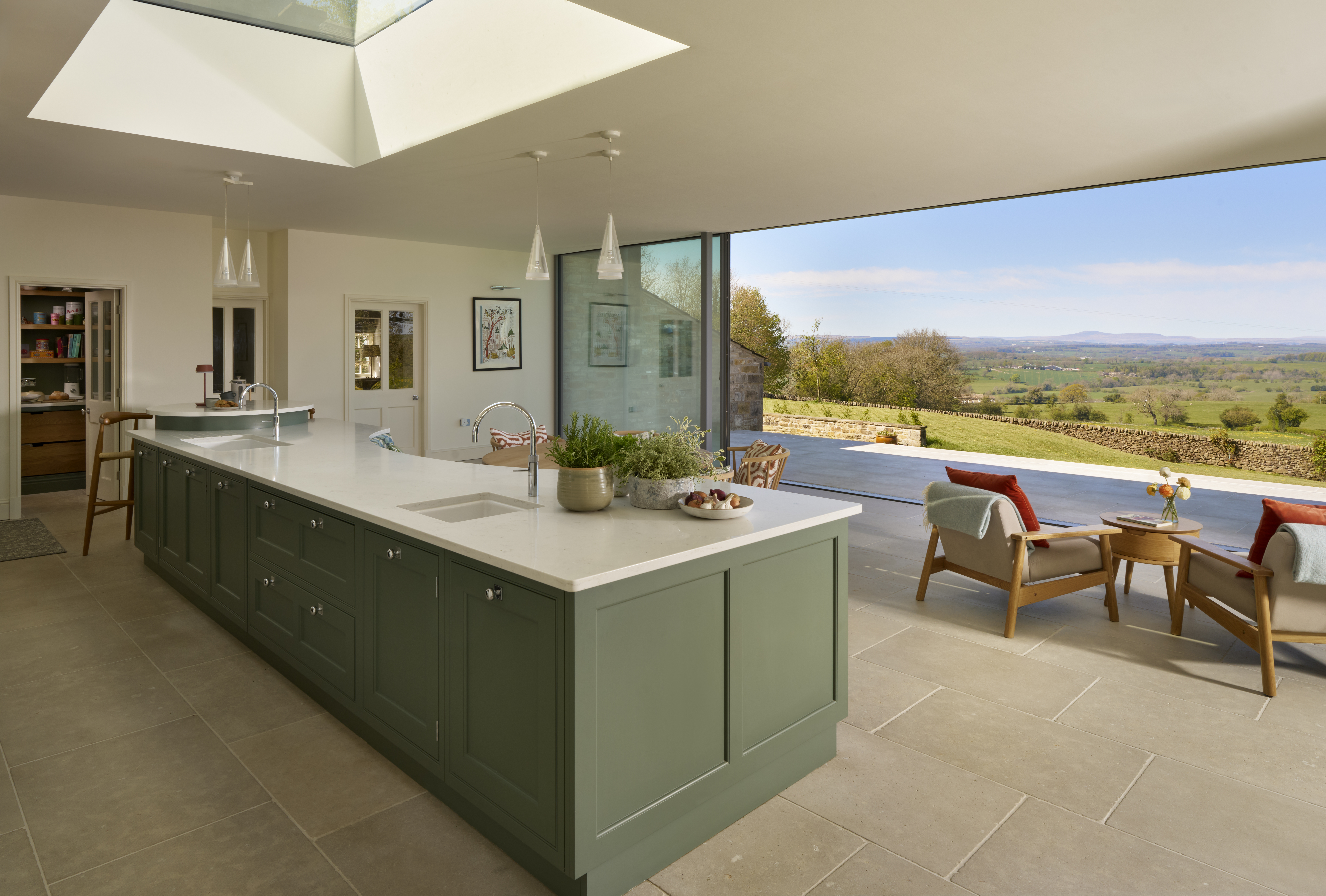 Country kitchen with green island and expansive view