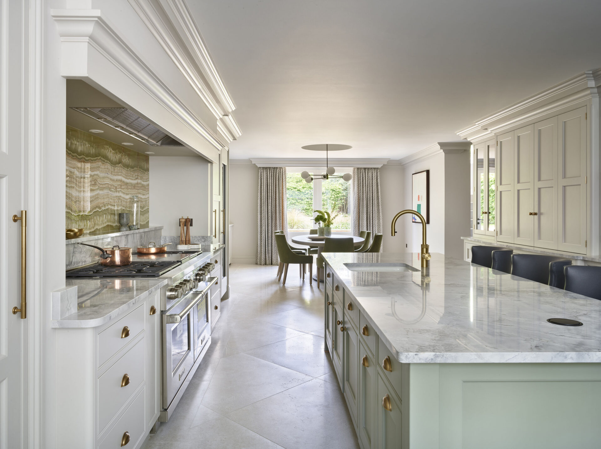 Light green kitchen island with matching green splashback