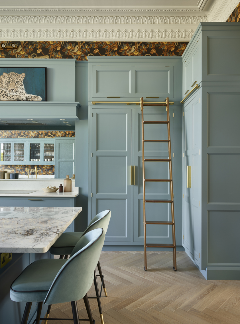 Townhouse kitchen featuring practical tall cabinets and sliding library ladder